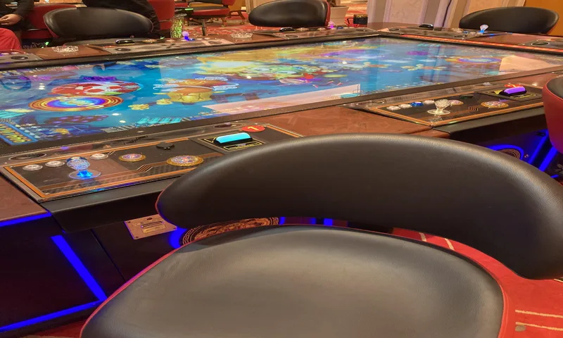 Arcade fish shooting game screen with laser cannons and deep sea boss monsters