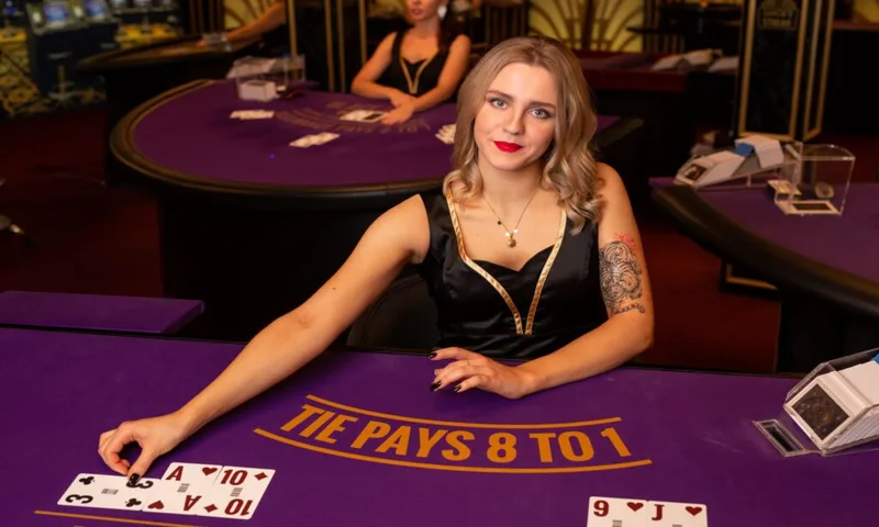Live dealer casino studio with elegant baccarat tables and professional dealers